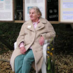Jane Pointer sitting on a chair at the open day of Kites Hill reserve